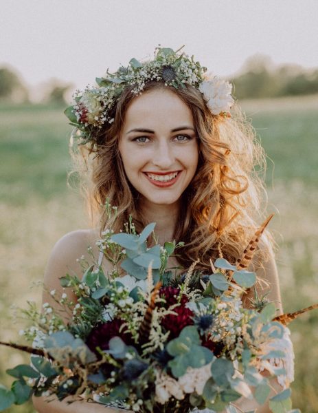 beautiful-young-bride-at-sunset-in-green-nature-PDXVRCK